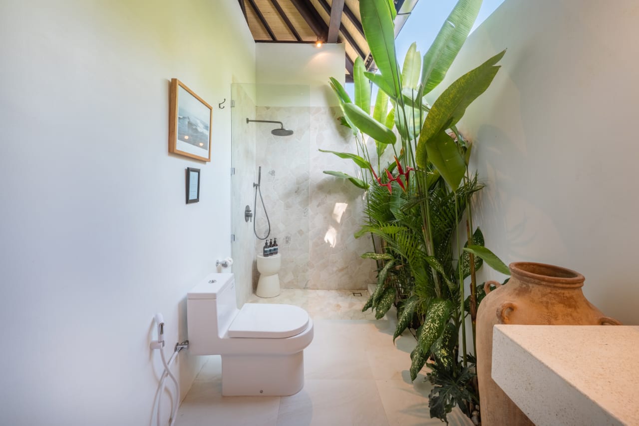 Garden bathroom with rain shower and tropical plants